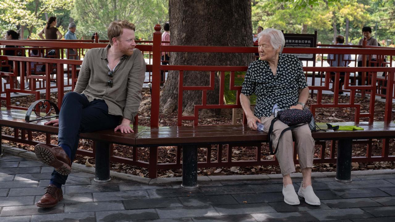 Glasgow talks with an elderly woman at Ritan Park in Beijing. Picture: Gilles Sabrie