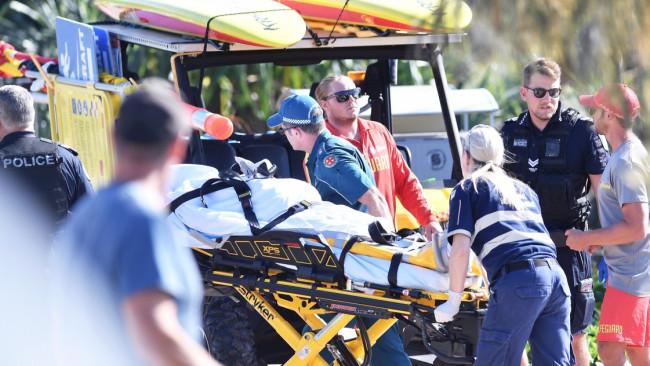 Paramedics load the woman's body into the ambulance. Photo Patrick Woods / Sunshine Coast Daily.