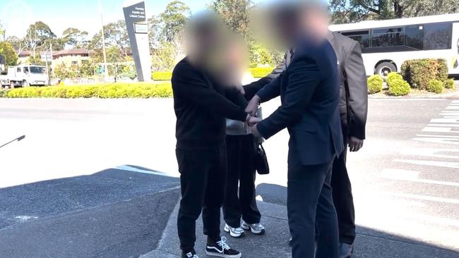 Xi Peng being arrested outside Hornsby police station. Picture: NSW Police