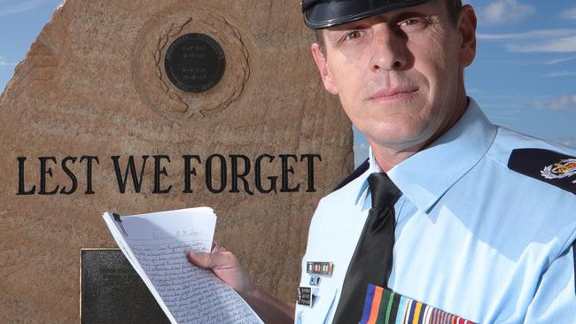 Sen-Sgt Tuffley holding Arthur Dean’s memoirs. Picture: Glenn Hampson