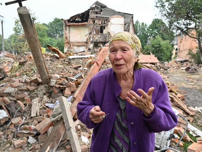 A local resident, Raisa Kuval, 82, reacts next to a damaged building partially destroyed after a shelling in the city of Chuguiv, east of Kharkiv. Picture: AFP