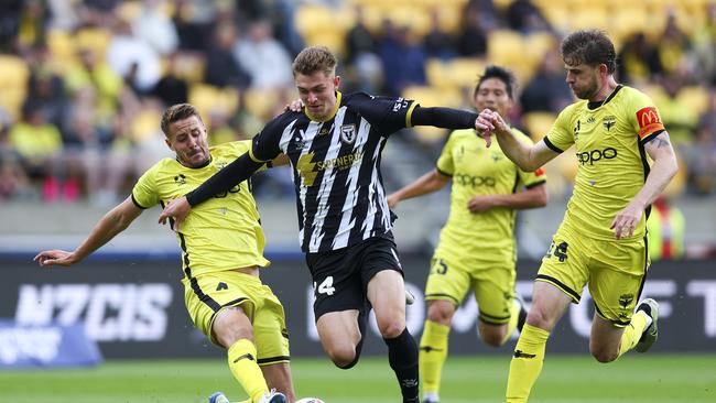 WELLINGTON, NEW ZEALAND – DECEMBER 14: Dean Bosnjak of Macarthur FC is tackled by Scott Wootton of the Phoenix during the round eight A-League Men match between Wellington Phoenix and Macarthur FC at Sky Stadium, on December 14, 2024, in Wellington, New Zealand. (Photo by Hagen Hopkins/Getty Images)