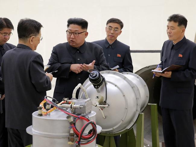 Kim Jong-un inspects the loading of a hydrogen bomb into a new intercontinental ballistic missile. Picture: Korean Central News Agency/Korea News Service via AP