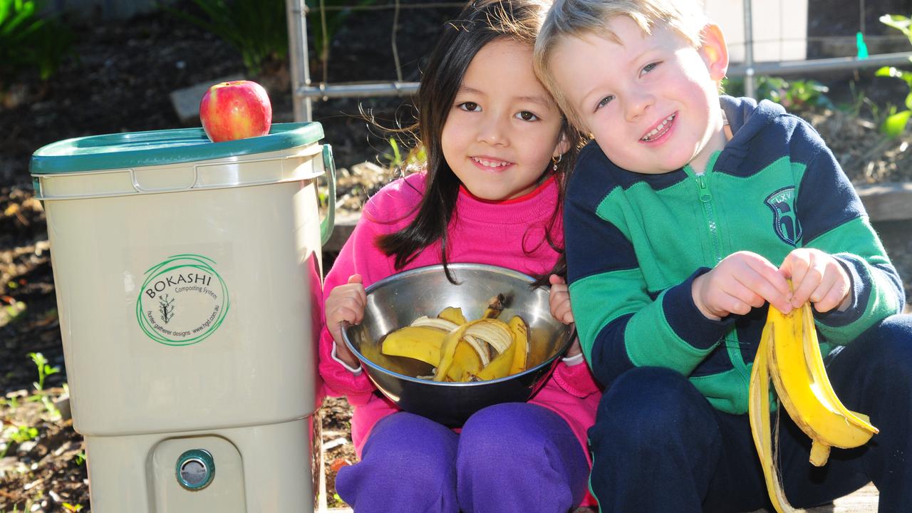 Belinda and Riley at kindergarten with a Bokashi Bin, that makes compost from food scraps.