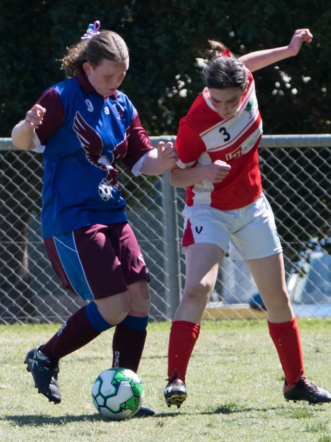 Close tackling contact from the under 15/16 girls Queensland Christian Soccer Association grand final between Blackstone and Brisbane Valley. Picture: Gary Reid