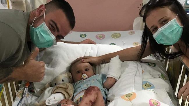 Jai Sheridan and Elisha Robinson with their eight-month-old baby Lilliana in a Thai hospital.