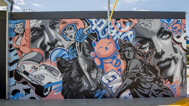 Artist Alex Lehours at work for a story on graffiti-inspired murals at the new Freedom Fuels service station on Bundall Rd. Picture: Jerad Williams