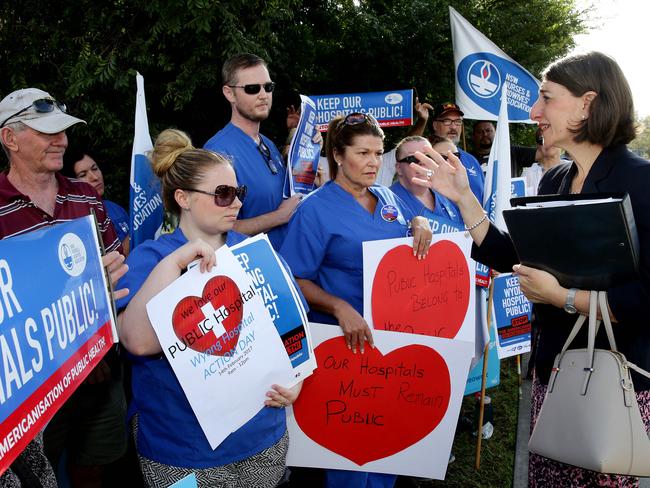 Premier Gladys Berejiklian talks with protesters about their hospital privatisation concerns. Picture: Sue Graham