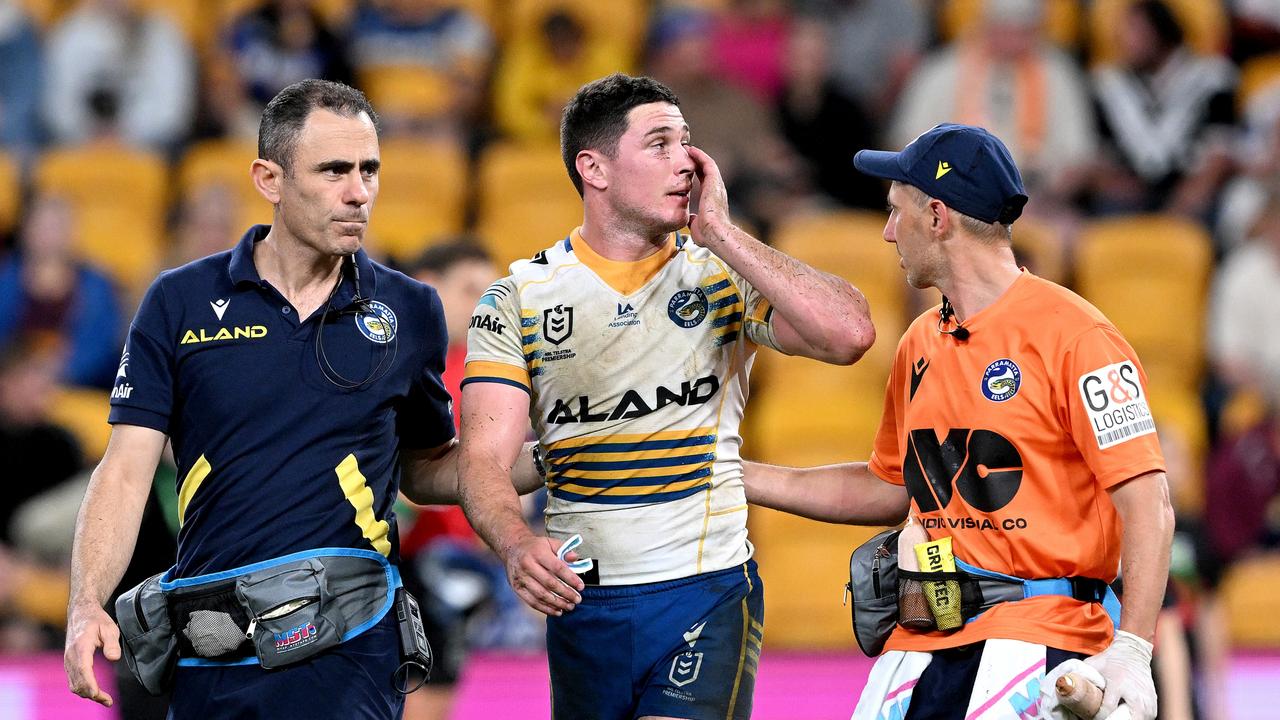 Mitch Moses is taken from the field for a HIA.