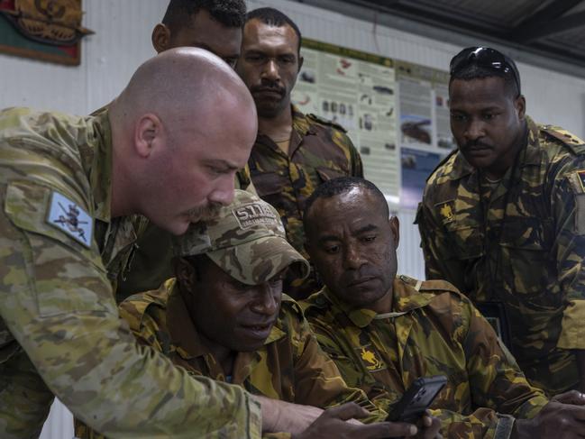 Australian Army officer Major Taylor Lynch from the 3rd Brigade Public Affairs Cell assists Papua New Guinea Defence Force members during the Smartphone Photography Course on 08 April 2024 at Camp Key, Wewak, Papua New Guinea. Photo: CPL Guy Sadler