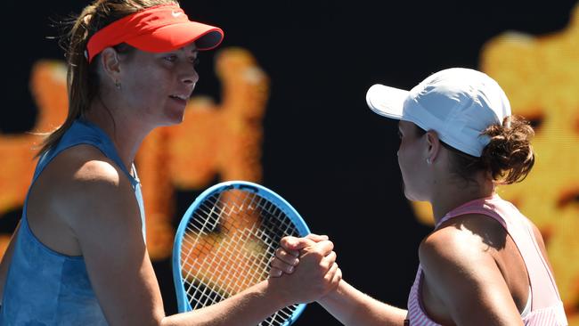 Russia's Maria Sharapova (L) congratulates Australia's Ashleigh Barty (R) for her victory in their women's singles match on day seven of the Australian Open tennis tournament in Melbourne on January 20, 2019. (Photo by Greg Wood / AFP) / -- IMAGE RESTRICTED TO EDITORIAL USE - STRICTLY NO COMMERCIAL USE --