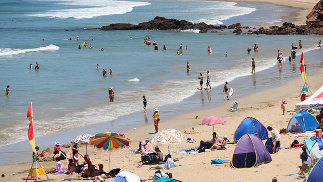 Lifeguards struggle to keep swimmers inside the flags at Anglesea surf beach. Picture: Alex Coppel