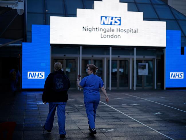 Medical staff from Britain’s NHS (National Health Service) walk outside the ExCeL London exhibition centre, which has been transformed into the NHS Nightingale field hospital. Picture: AFP