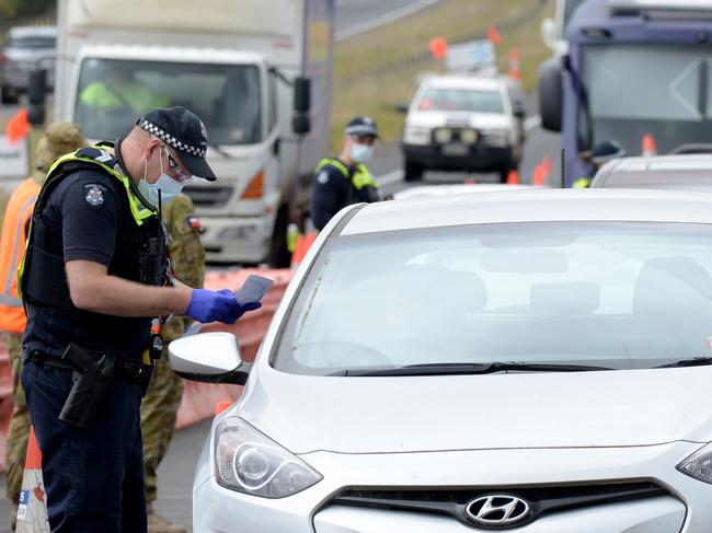 Police and ADF personnel at a checkpoint heading out of Melbourne on the Western Freeway at Bacchus Marsh. Picture: Andrew Henshaw