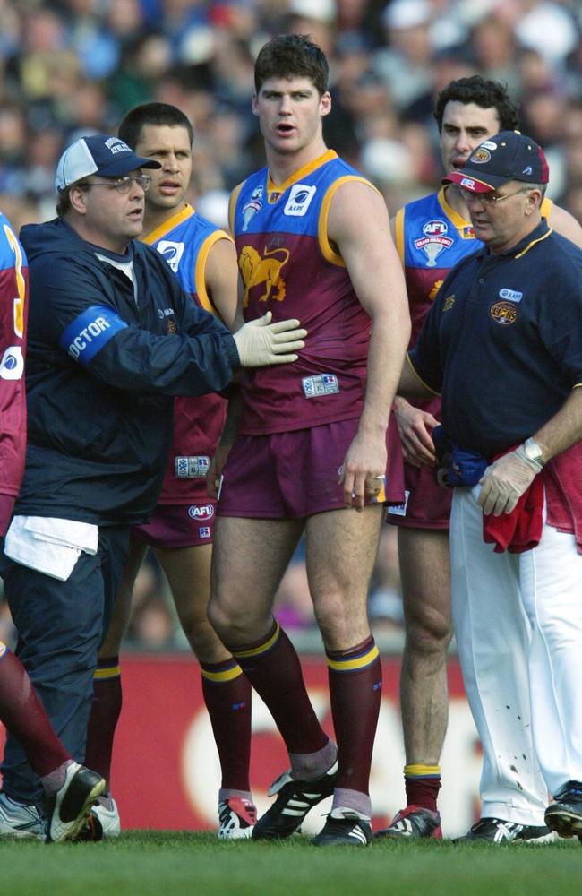 Jonathan Brown in the hands of the trainers after being levelled by Scott Burns. Picture: Craig Borrow