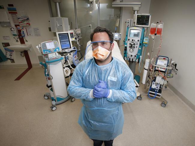 Senior ICU nurse educator Travis Bird, from Melbourne’s Alfred Hospital. stands ready with all the equipment to save lives. Picture: David Caird