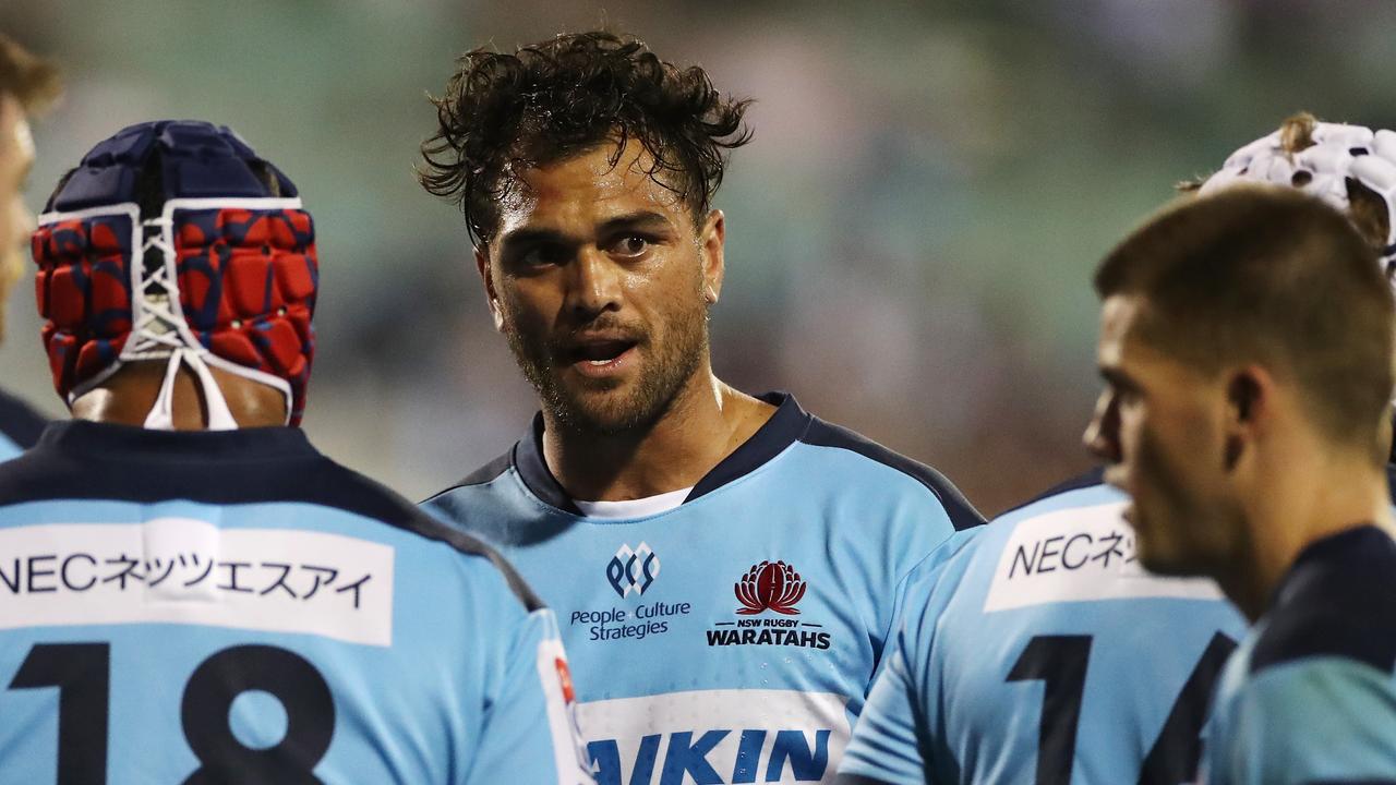 Karmichael Hunt of the Waratahs talks to teammates after a Chiefs try.