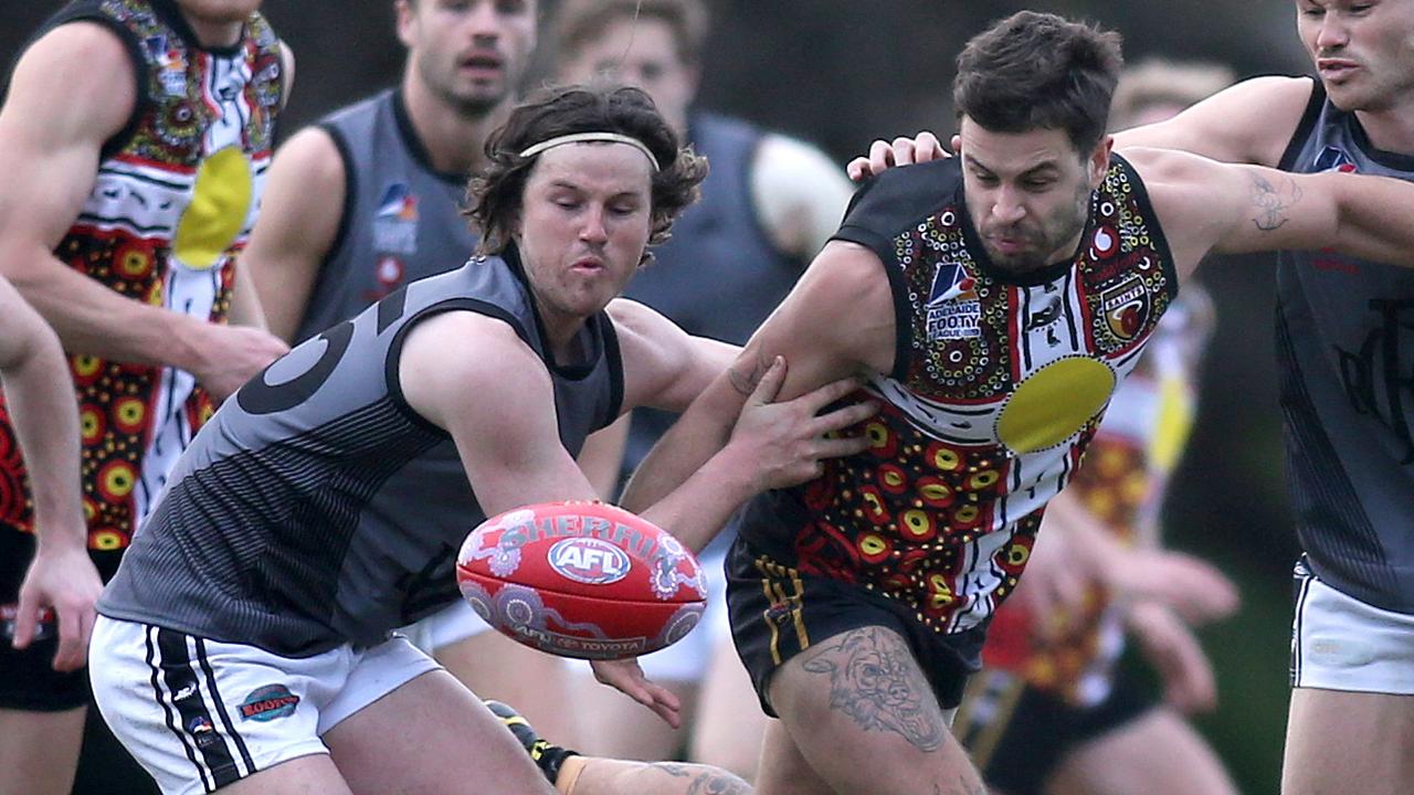 Goodwood Saints v Port District in a division one round three clash at Goodwood Oval. SaintÃs Jacob Hughes tries to break through, with close attention from PortÃs Mitchell Gaffney (R), and Cooper Gaffney (L).18 July 2020. Picture Dean Martin