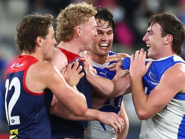 Clayton Oliver of the Demons and George Wardlaw of the Kangaroos wrestle during the round 15 AFL match between Melbourne Demons and North Melbourne Kangaroos at Melbourne Cricket Ground, on June 22, 2024, in Melbourne, Australia. (Photo by Quinn Rooney/Getty Images)