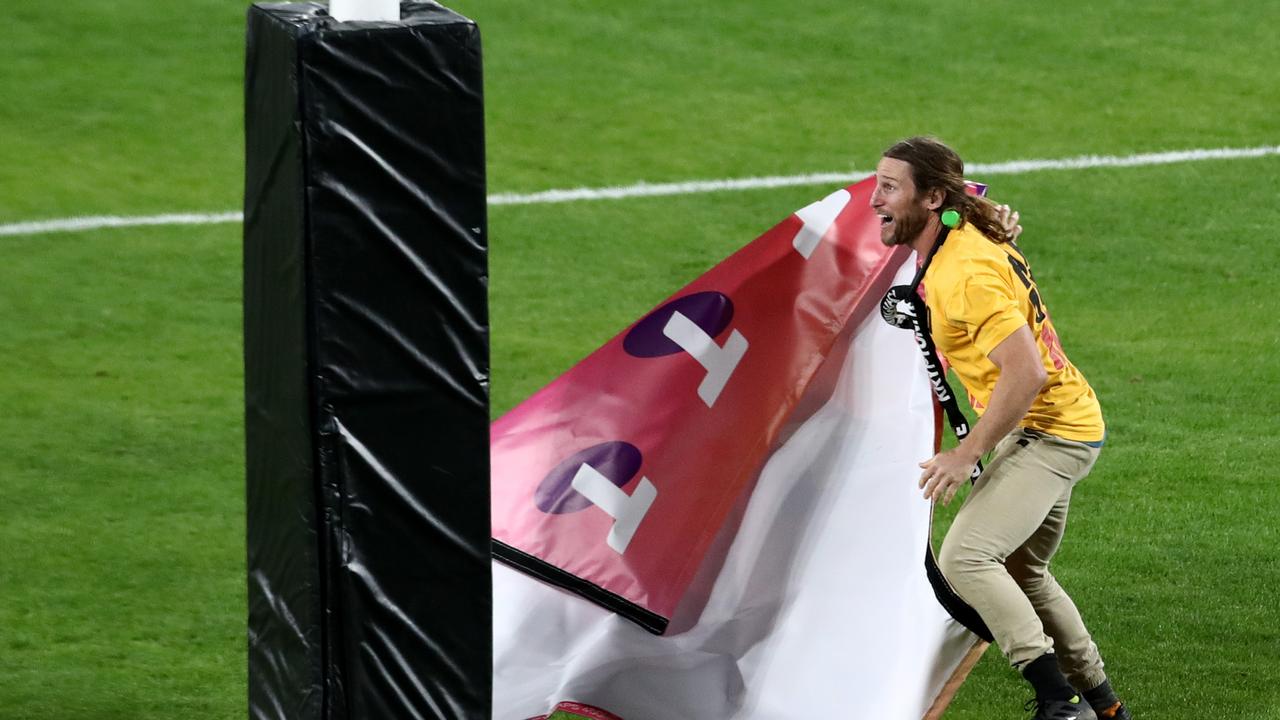 Mark McLinden rips padding off a post during the NRL Grand Final.