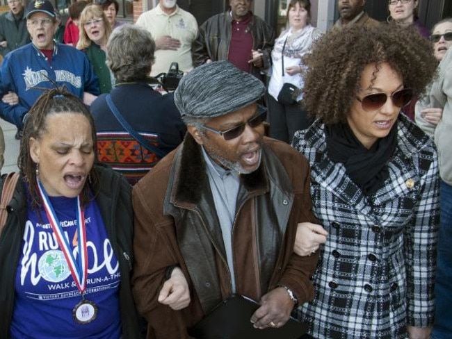 Della Montgomery-Riggins, Charles Thornton and Rachel Dolezal link arms and sing ‘We Shall Overcome’ at a rally in Washington in March 2015.