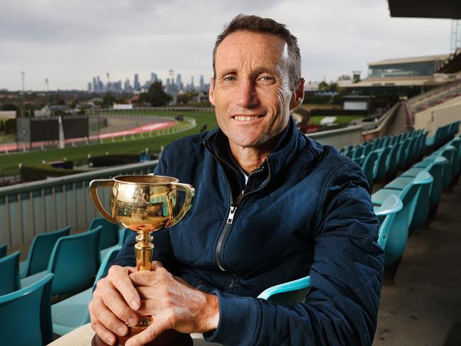 Champion jockey Damien Oliver retiring from horse racing. Damien in the stands holding one of his Melbourne Cups at Moonee Valley.                      Picture: David Caird