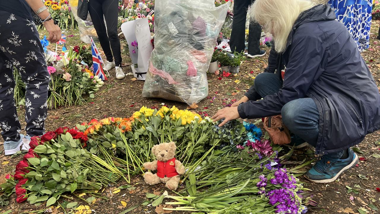 One woman was rearranging flowers that had been taken out of their wrapping into a rainbow. Picture: Chantelle Francis