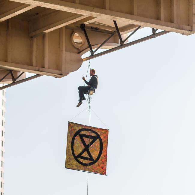 An Extinction Rebellion protester Sean Nolan abseiling off William Jolly Bridge. Picture: Supplied.