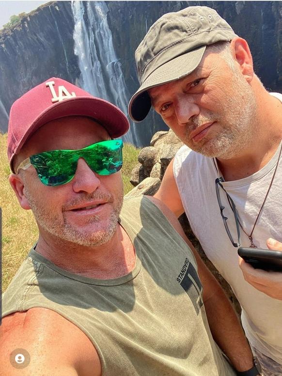 Aaron Coshaw (right) with his partner Jay Horne at Victoria Falls in Zambia just before Mr Coshaw collapsed. Picture: Instagram