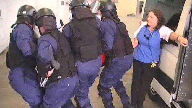 Body cam footage shows the difficulty for officers in moving an unco-operative detainee. Picture: Supplied