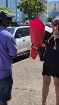 Darwin ex-real estate agent Suzi Milgate receives flowers outside court