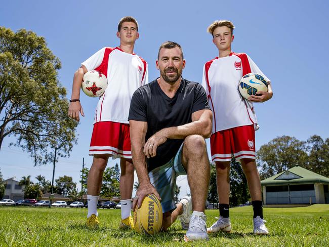 Former NRL player Darren Anderson with football-playing sons Hayden and Lachlan. Picture: Jerad Williams