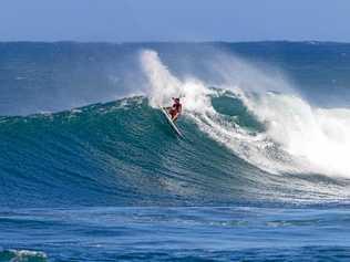 ON A HIGH: The Gold Coast's Jack Freestone has fought his way back onto the WSL World Tour after making the quarter finals of the Vans World Cup at Sunset Beach in Hawaii. Inset: Jack Freestone and his   son, Banks. Picture: Keoki Saguibo