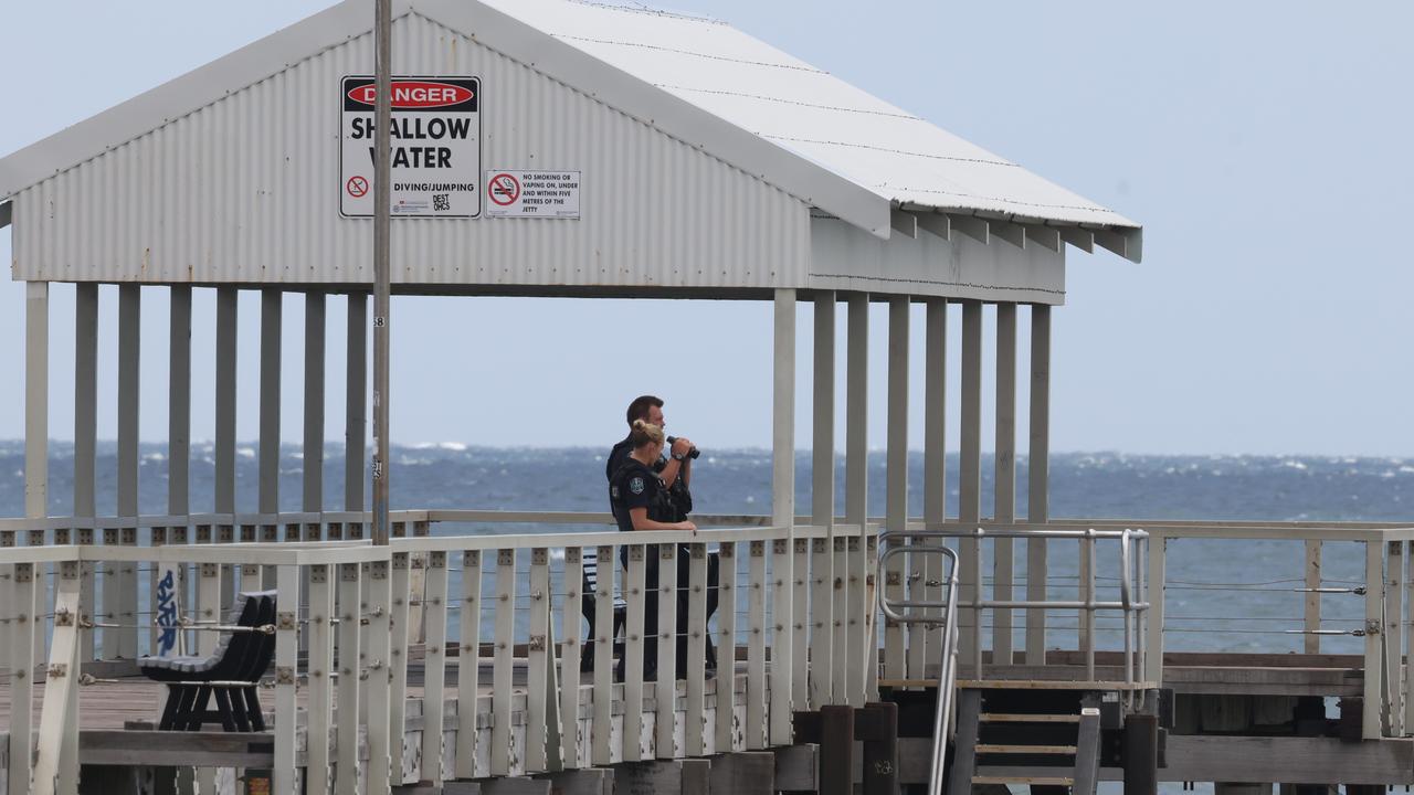 Police cast a search of the water from the jetty. Picture: Russell Millard Photography