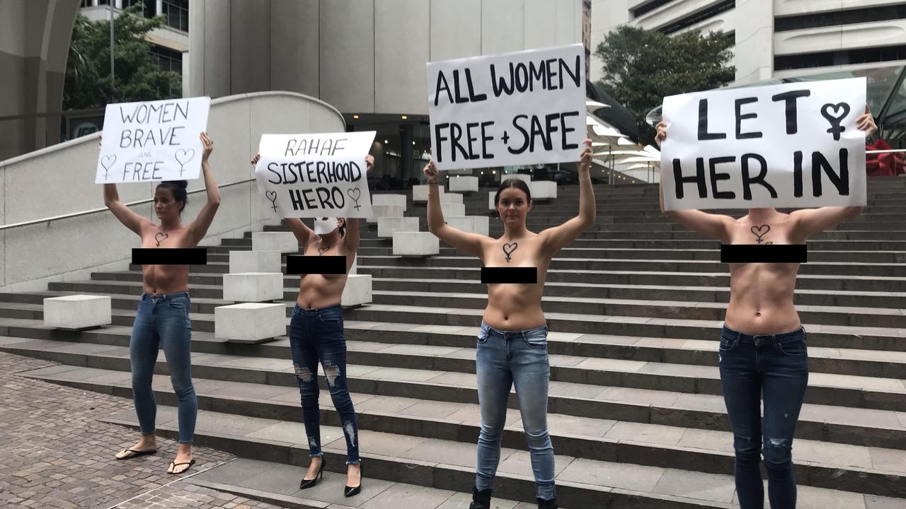 The women held signs for 45 minutes, wearing nothing but jeans, during the morning rush.