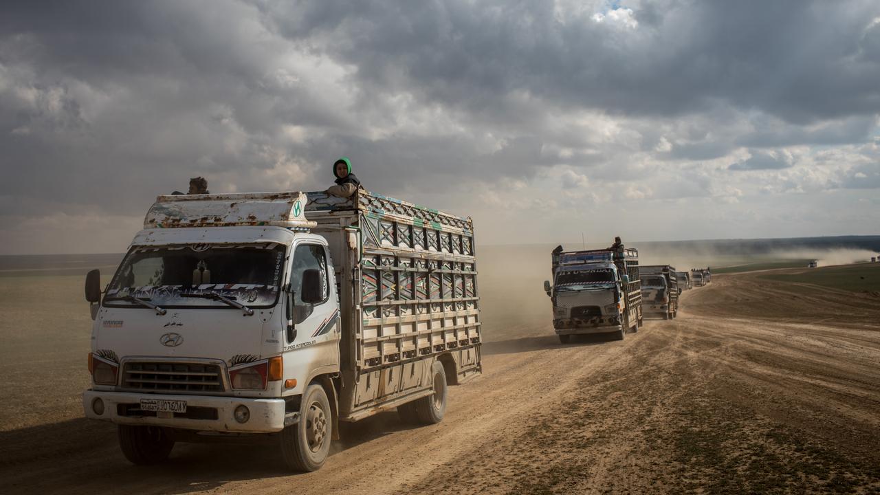 Trucks of civilians who have fled fighting in Bagouz are transported to a camp after being screened by members of the SDF at a makeshift screening point in the desert. Picture: Chris McGrath/Getty Images