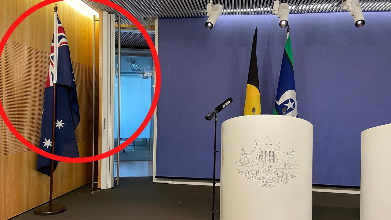 Greens leader Adam Bandt has the Australian flag moved when he gave a press conference this week.