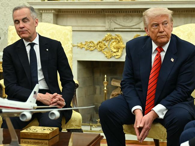 US President Donald Trump and Canadian Prime Minister Mark Carney look on as they meet in the Oval Office of the White House in Washington, DC, on May 6, 2025. (Photo by Jim WATSON / AFP)