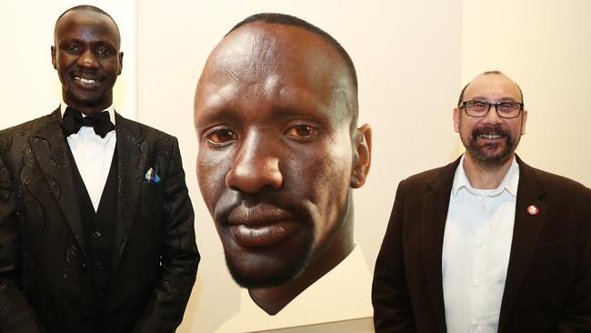 Deng Adut with his portrait and Blacktown artist Nick Stathopoulos at the Art Gallery of NSW. Picture. Brett Costello