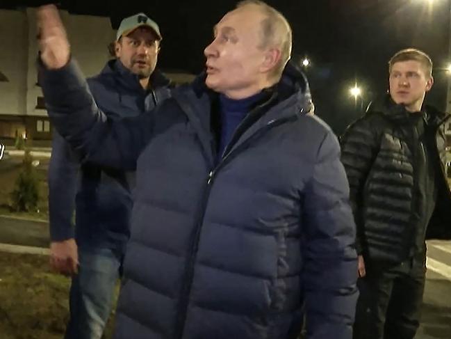 Vladimir Putin speaking with people at a newly built neighbourhood during his visit to Mariupol in Russian-controlled Donetsk region. Picture: Russian Presidential Press Office / AFP