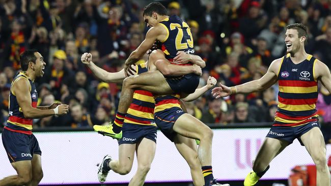 Charlie Cameron jumps on debutant Jono Beech after he kicked his first ever AFL goal. Picture: Sarah Reed