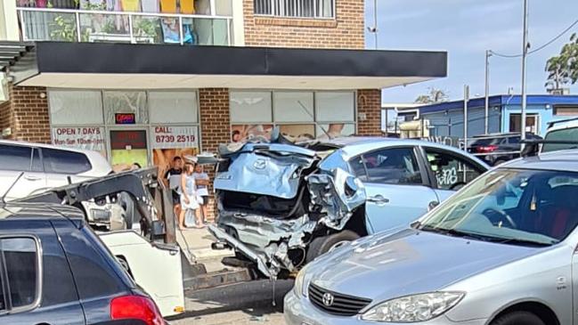 A Mazda sedan is towed away after it was involved in a seven-car pileup on Helen St, Sefton. Picture: Supplied.