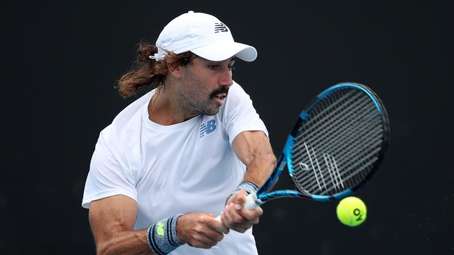 MELBOURNE, AUSTRALIA - JANUARY 05: Jordan Thompson of Australia plays a backhand in his match against Christopher O'Connell of Australia during day three of the Melbourne Summer Events at Melbourne Park on January 05, 2022 in Melbourne, Australia. (Photo by Graham Denholm/Getty Images)