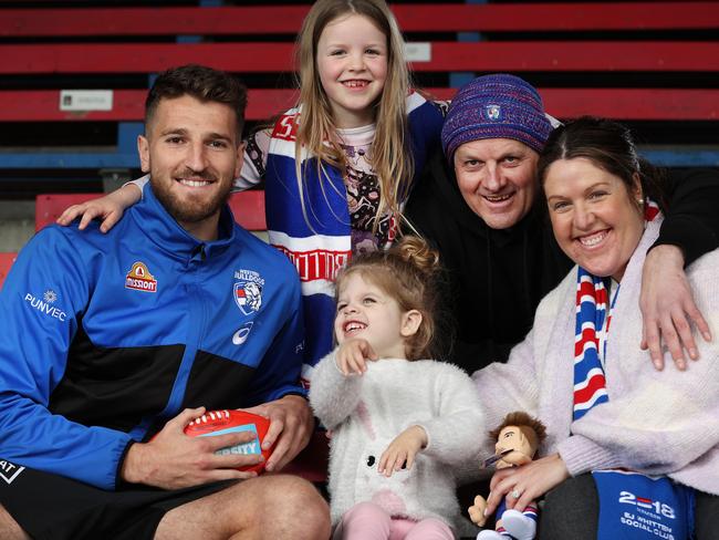 DonateLife 2021 campaign - this Saturday is DonateLife match between Western Bulldogs and Sydney Swans. The Bulldogs are a DonateLife sporting partner this year. Bulldogs player Marcus Bontempelli with 3yr old liver donation recipient Maia Govan and her family, parents Richard and Tara Govan and sister Luna 7 at Whitten Oval.  Picture: David Caird