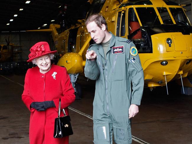 Queen Elizabeth II (L) is escorted by her grandson Prince William during a visit to RAF Valley in Wales in 2011. Picture: AFP