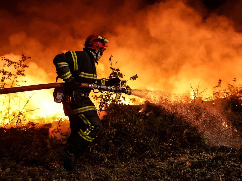 A firefighter tackles a forest fire near Louchats in Gironde, southwestern France . (Photo by THIBAUD MORITZ / AFP)