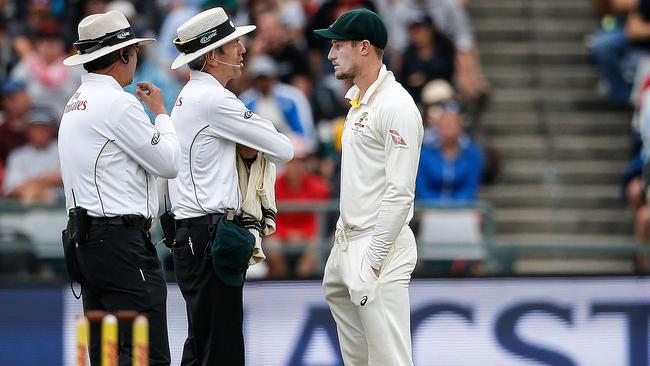 Umpires Richard Illingworth (left) and Nigel Llong question Australian fieldsman Cameron Bancroft during the third day of the third Test in Cape Town.