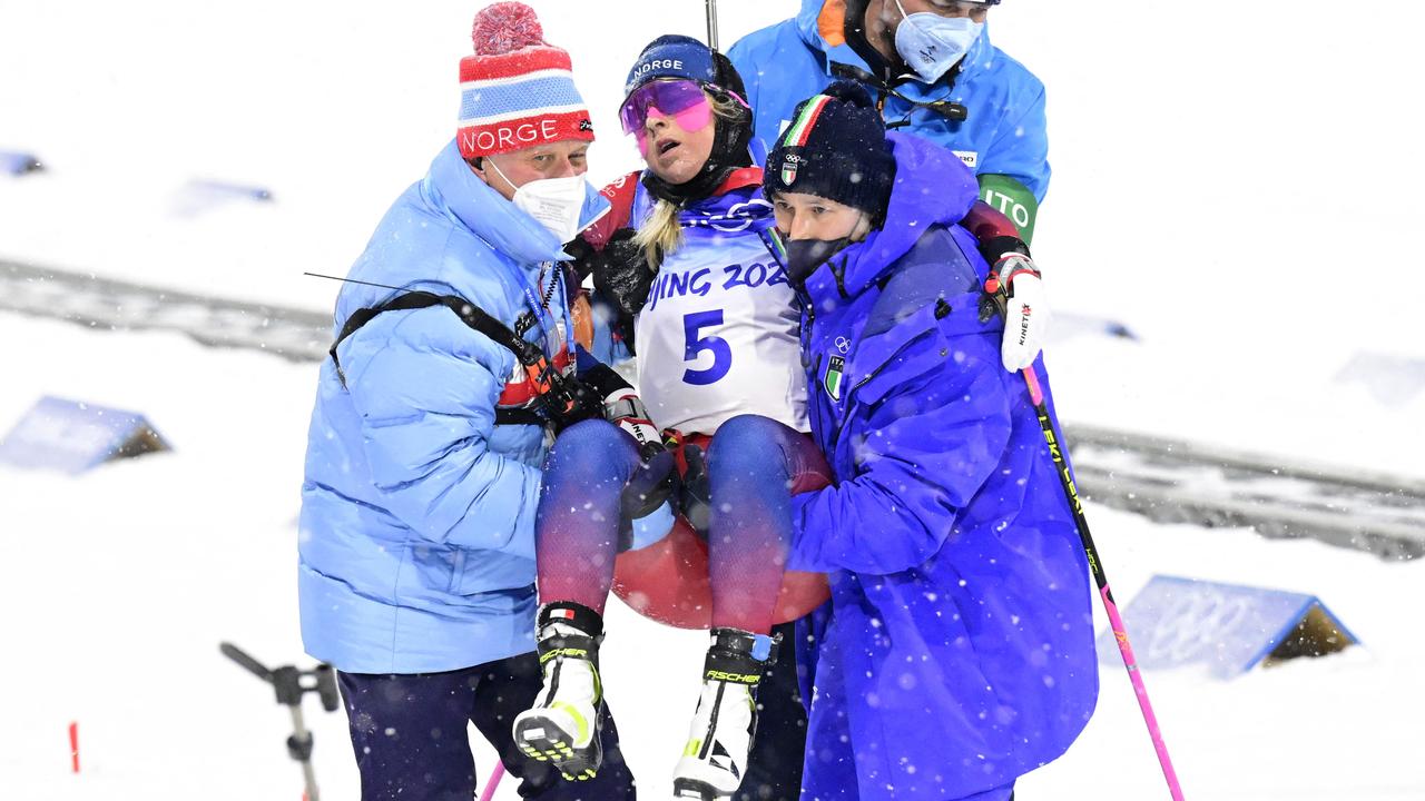 She was then carried away, too weak to walk. Picture: Tobias Schwarz / AFP