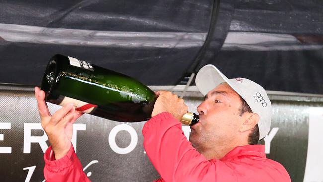 Mark Richards drinks champagne after docking in Hobart. Picture: Richard Jupe