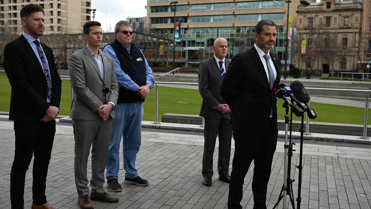 (L-R) Master Builders SA Director Kym Morgan, SA Unions Secretary Dale Beasley, AWU SA Branch Secretary Peter Lamps, Housing Industry Association SA Director Stephen Knight and Industrial Relations Minister Kyam Maher (speaking) held a press conference in Victoria Square in regards to banning uncontrolled cutting of engineered stone. Picture: NCA NewsWire / Naomi Jellicoe